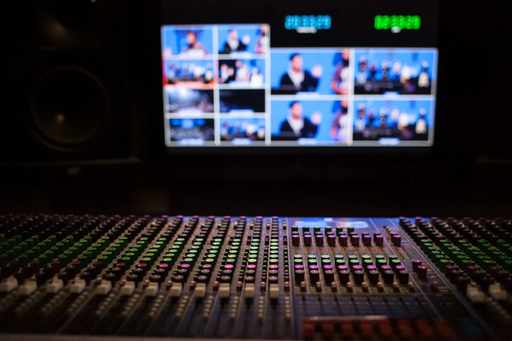 Broadcast control room with a multiviewer wall and mixing console during a live news show